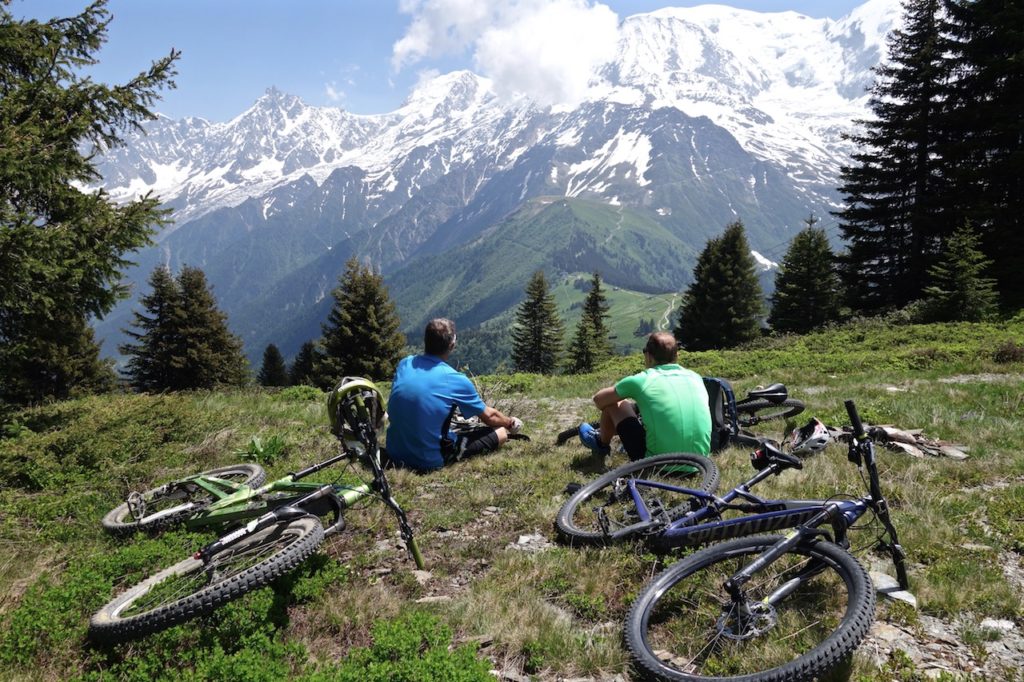 Mountain Bikers Takie in the awe inspiring view of Mont Blanc