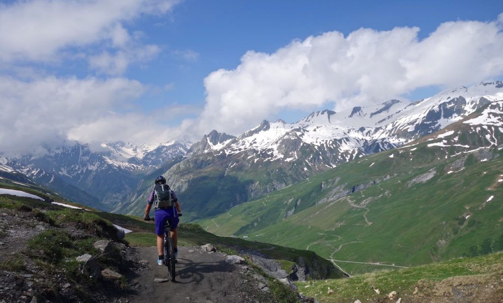 Mountain Biker riding the single trail with views in the Alps