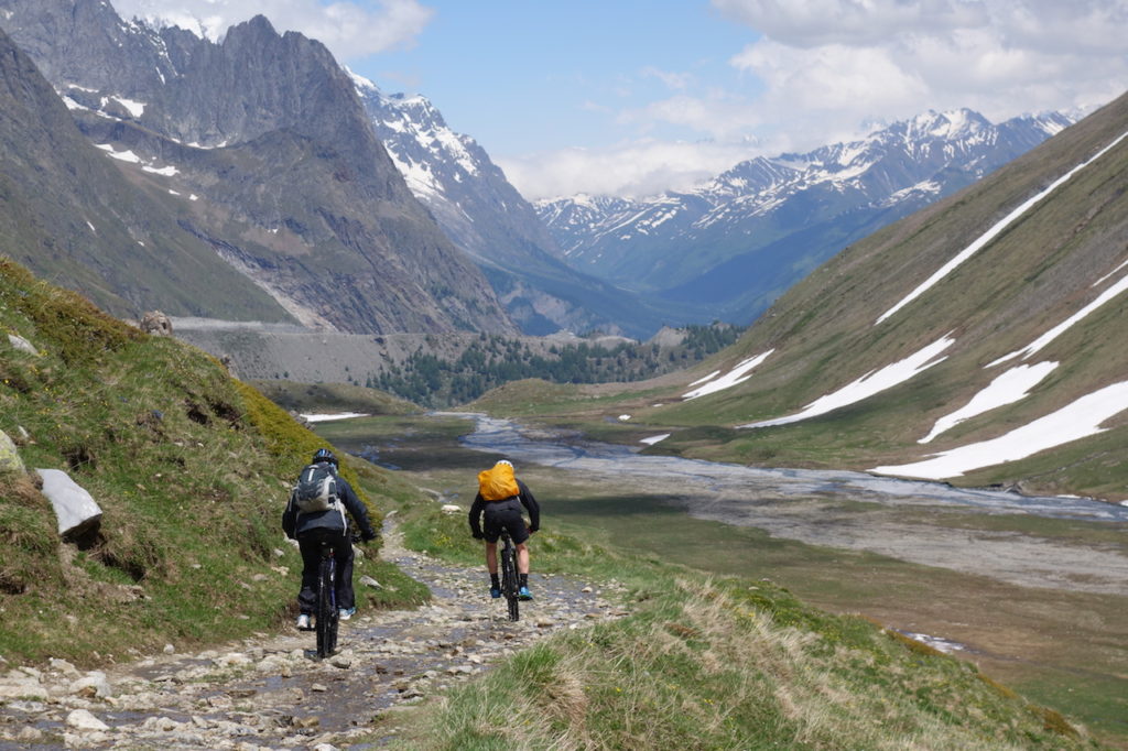 Mountain Biker riding the valley bottom in the Alps