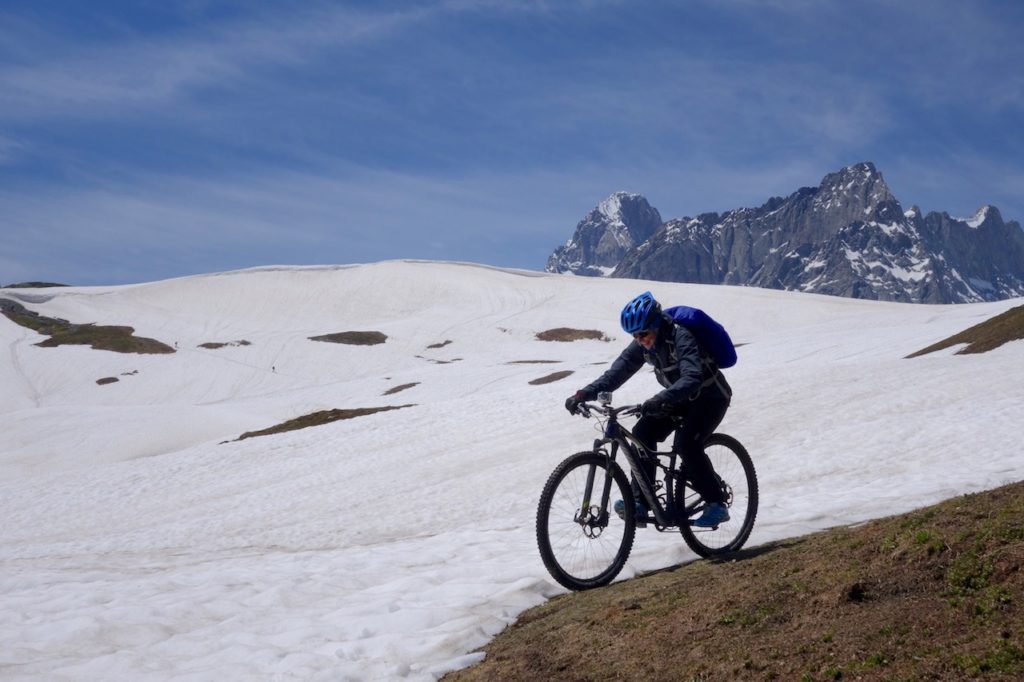 Mountain Biker riding in the snow in the Alps